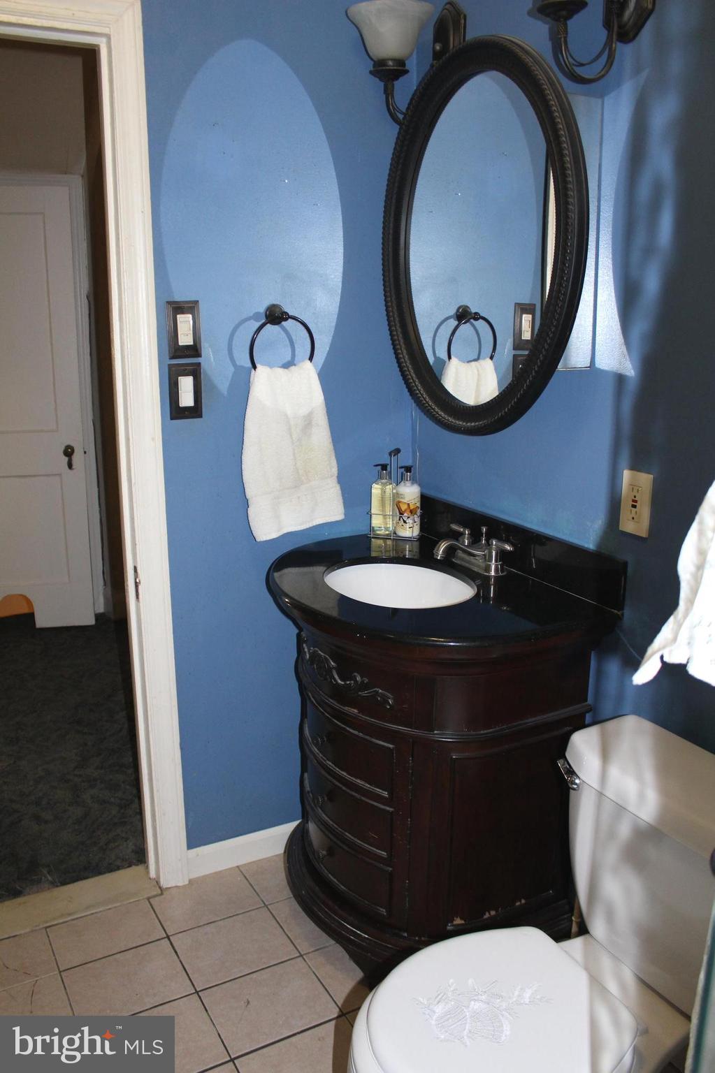 3015 Dunleer Road Baltimore, MD 21222 - Photo 12 of 18 a bathroom with a sink and a mirror
