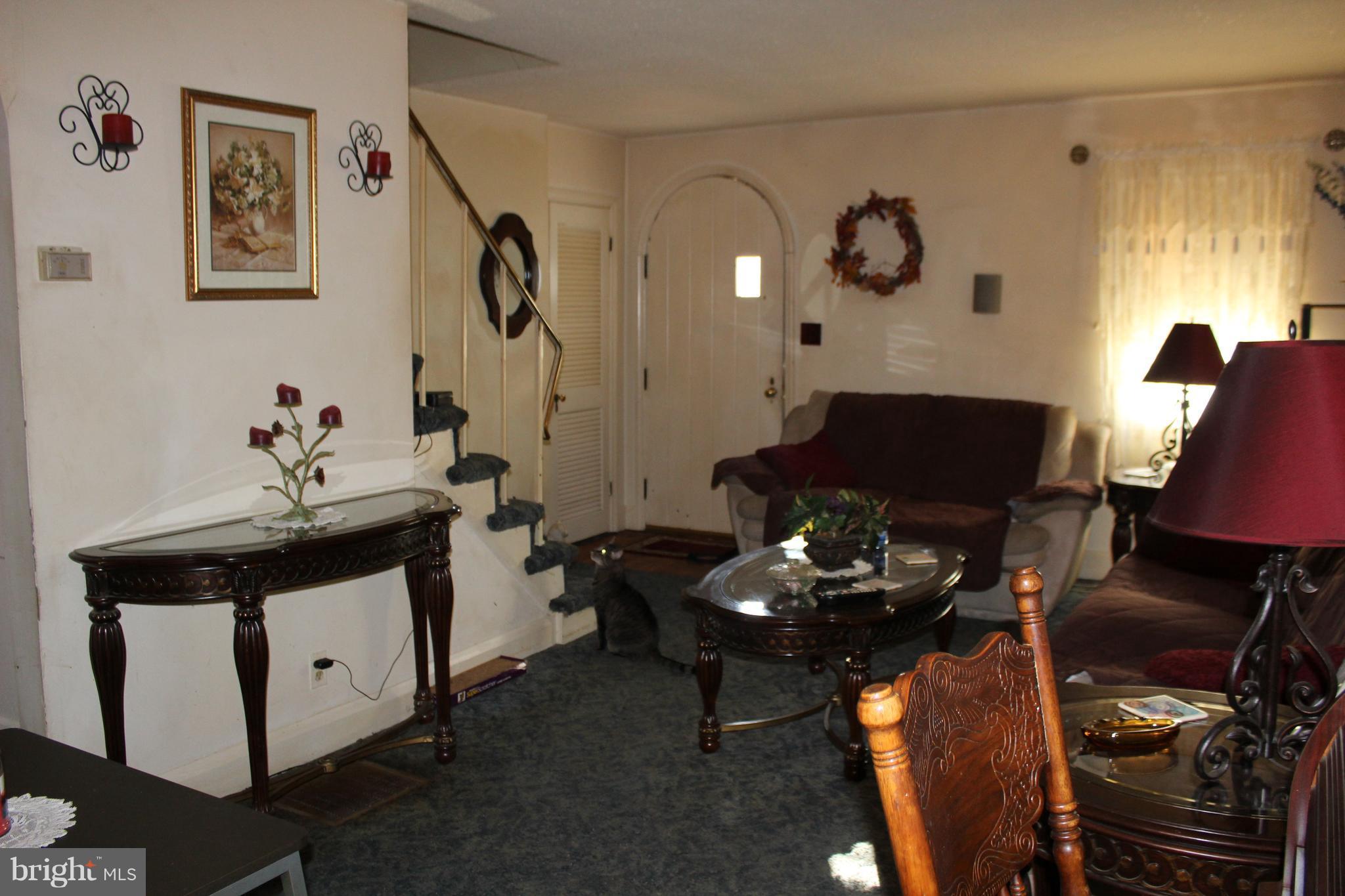 3015 Dunleer Road Baltimore, MD 21222 - Photo 14 of 18 a living room with furniture a fireplace and a window