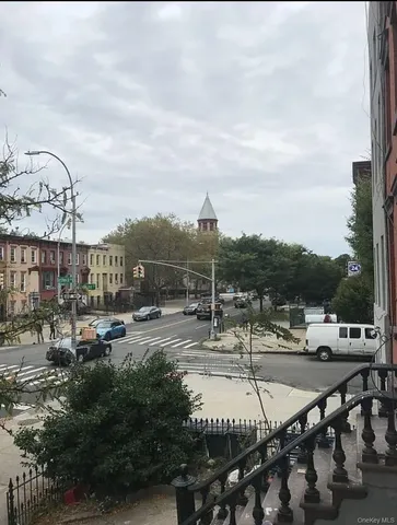 a view of a tennis ground with large trees