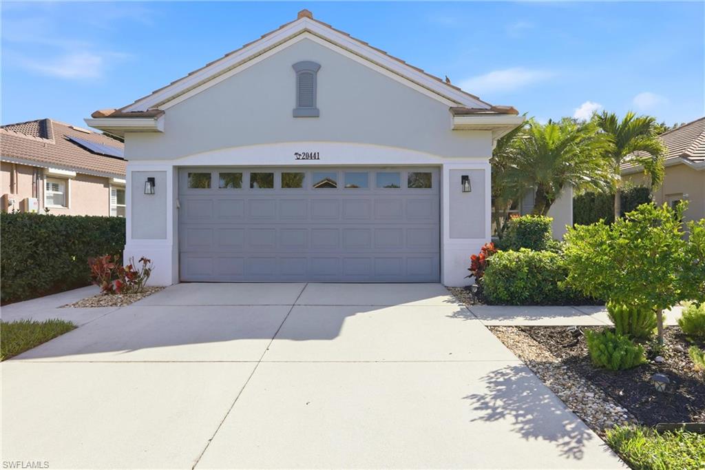 20441 Rookery Drive Estero, FL 33928 - Photo 1 of 41 a front view of a house with a yard and garage