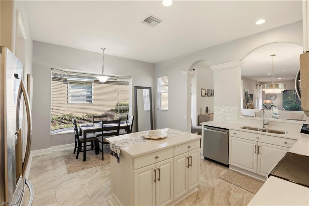 20441 Rookery Drive Estero, FL 33928 - Photo 16 of 41 a large kitchen with a table and chairs