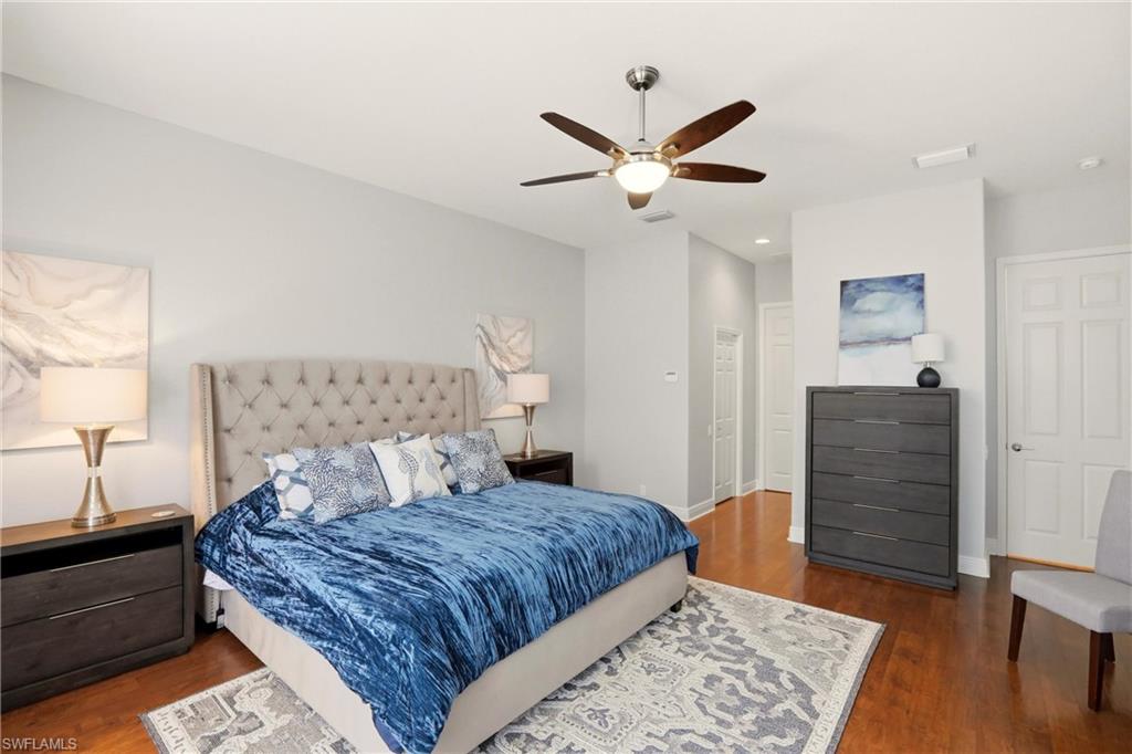 20441 Rookery Drive Estero, FL 33928 - Photo 17 of 41 a bedroom with a large bed and a chandelier
