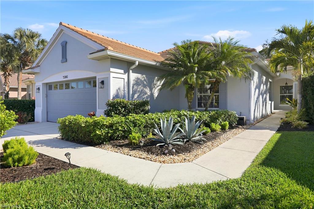 20441 Rookery Drive Estero, FL 33928 - Photo 2 of 41 a front view of a house with garden