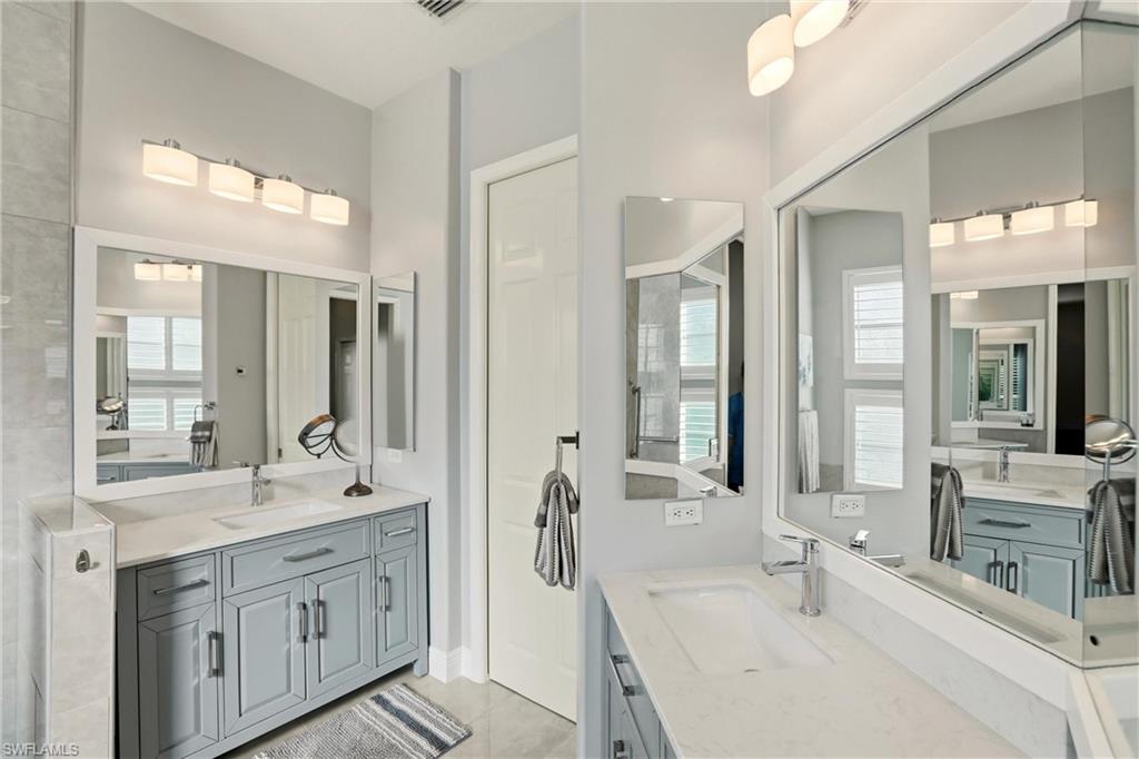 20441 Rookery Drive Estero, FL 33928 - Photo 21 of 41 a bathroom with double vanity sinks double vanity tub and a mirror