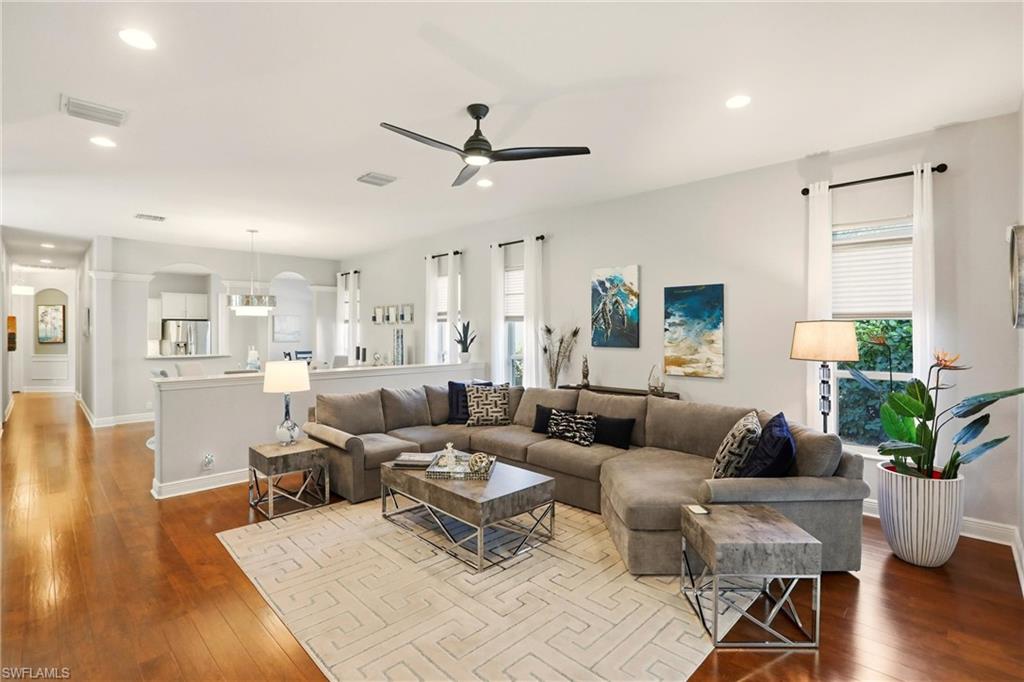 20441 Rookery Drive Estero, FL 33928 - Photo 9 of 41 a living room with furniture wooden floor and a chandelier