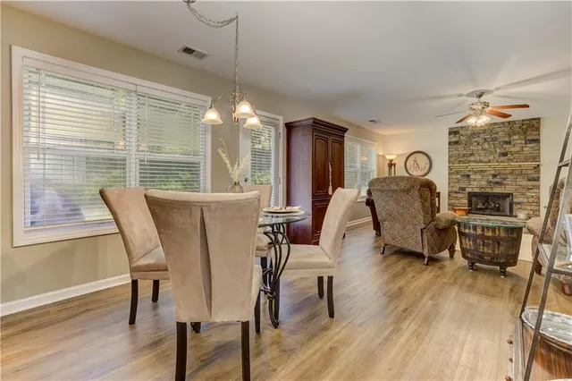 a living room with furniture ceiling fan and a window