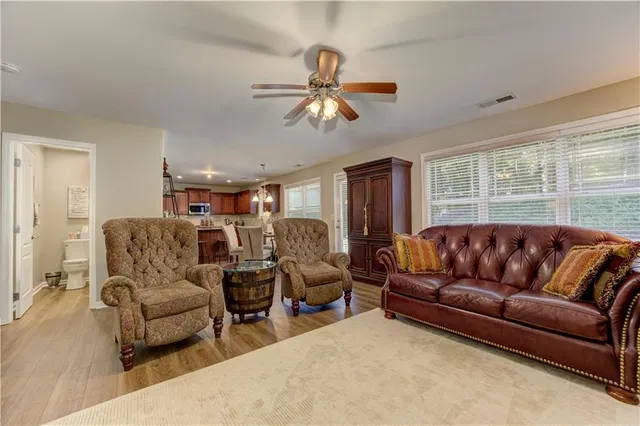 a large bedroom with a bed and a flat tv screen on dresser
