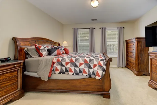 a front view of a house with a yard and potted plants