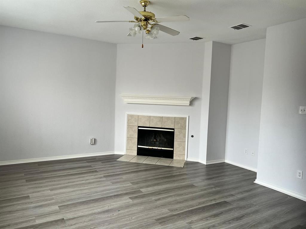 4312 Ridge Point Lane Plano, TX 75024 - Photo 10 of 16 wooden floor fireplace and natural light in room