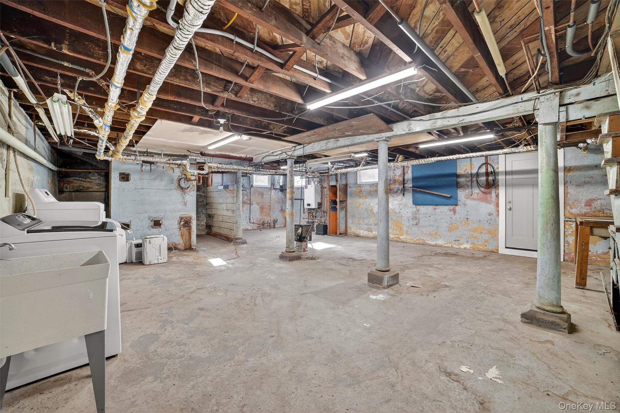 530 Dyckman Street Peekskill, NY 10566 - Photo 24 of 34 Full, unfinished basement with laundry, utilities and door to yard.