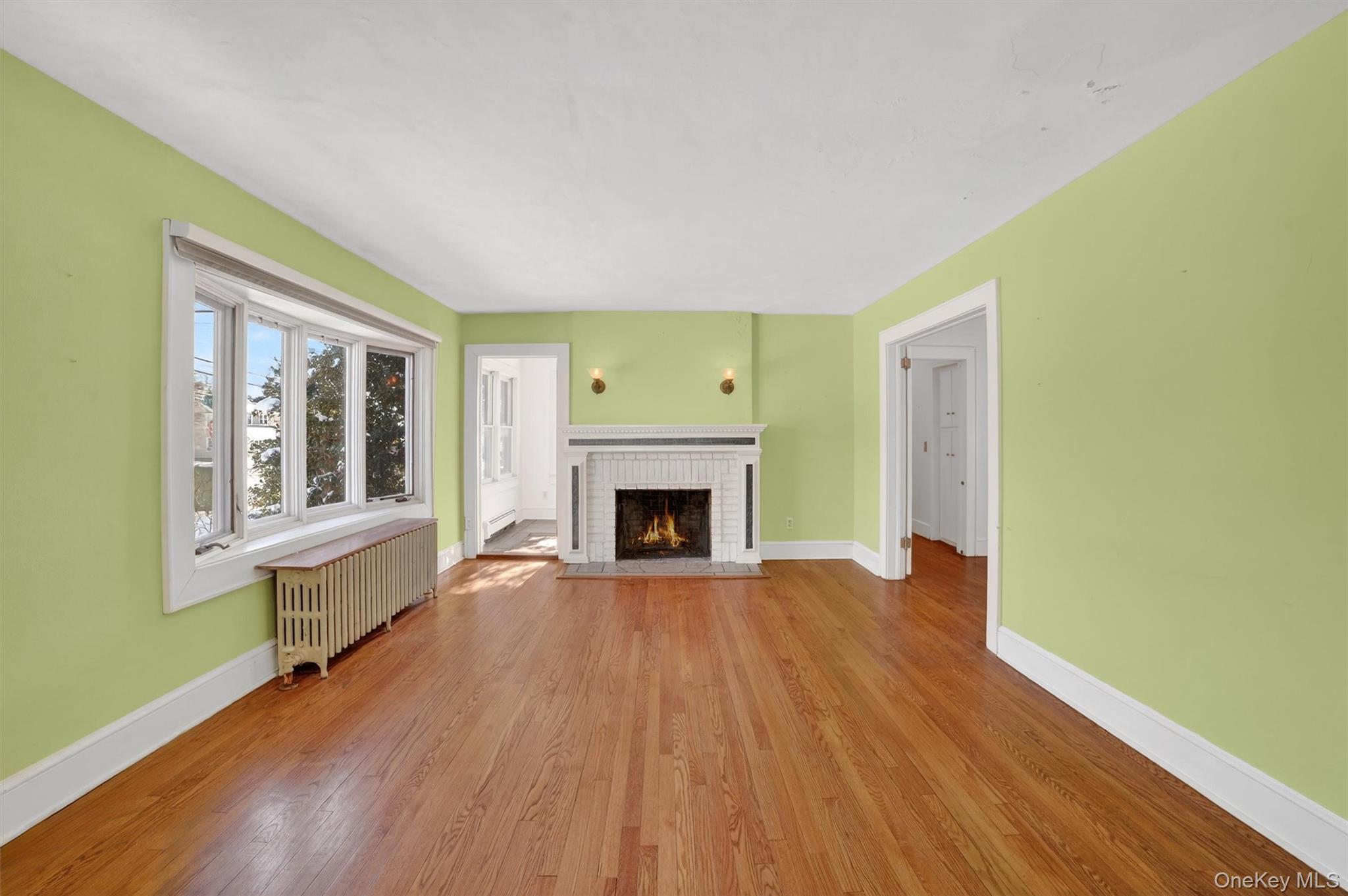 530 Dyckman Street Peekskill, NY 10566 - Photo 4 of 34 Large living room with wood burning fireplace, French door to sun room, French door to den and large picture window.