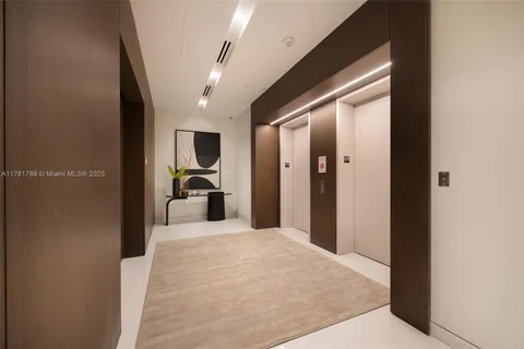 a en suite bathroom with a sink and a large mirror