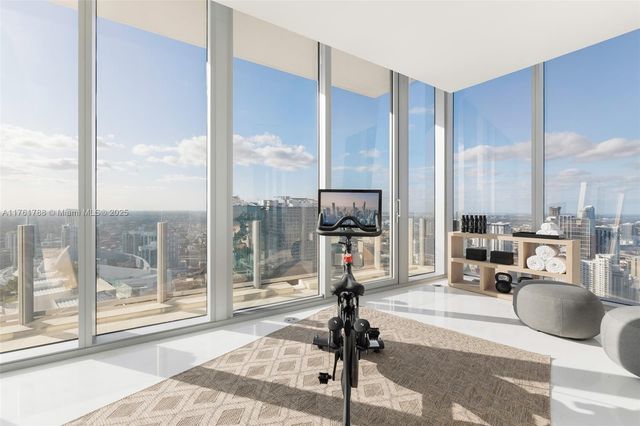 a view of a living room with floor to ceiling windows and floor to ceiling window