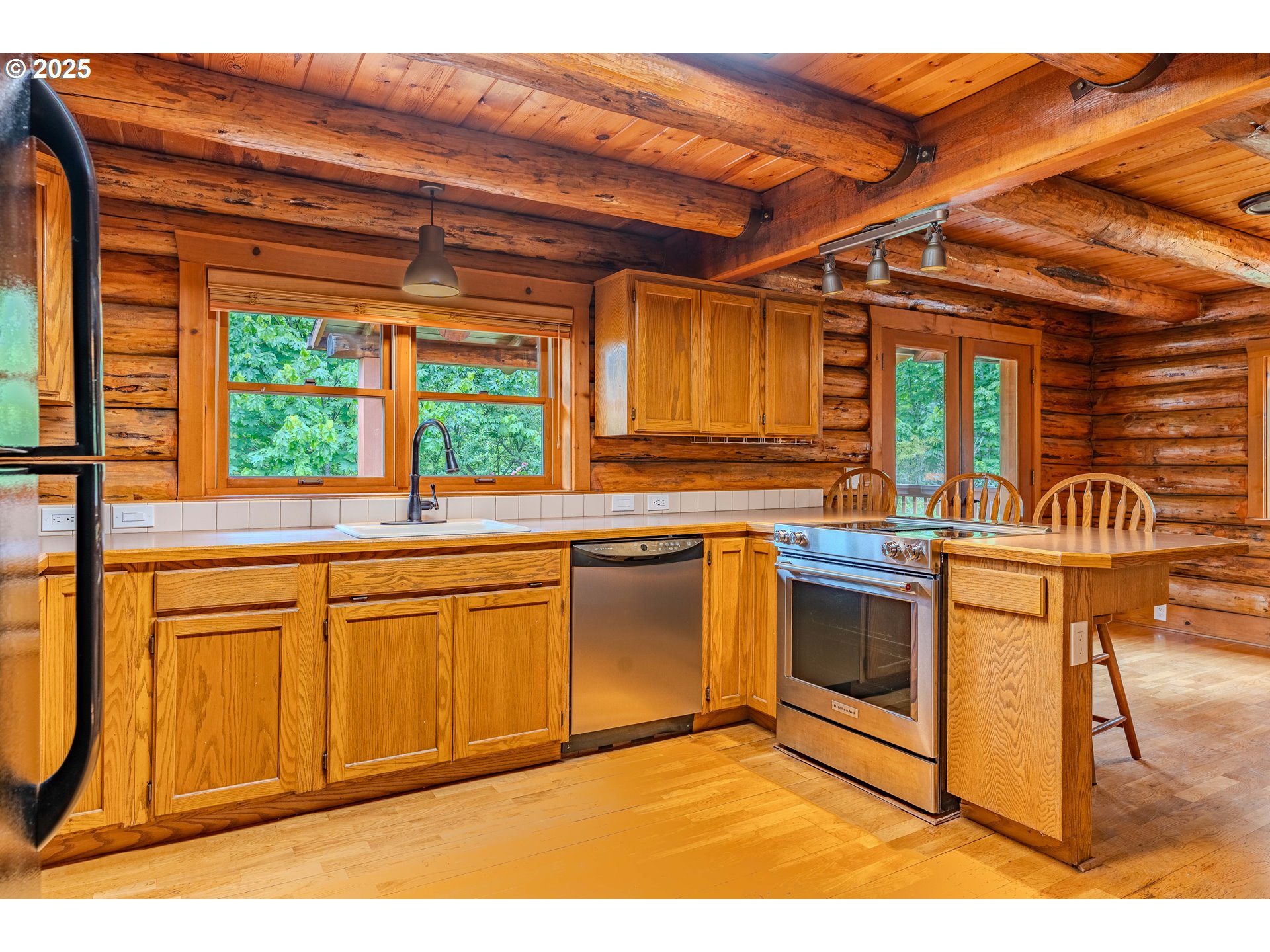 43144 Southeast Deverell Road Corbett, OR 97019 - Photo 12 of 48 a kitchen with stainless steel appliances granite countertop a stove a sink and a microwave