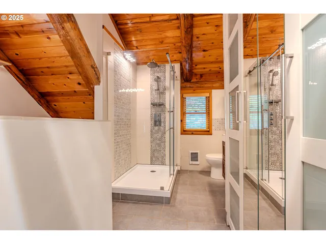 a bathroom with a toilet a sink and shower