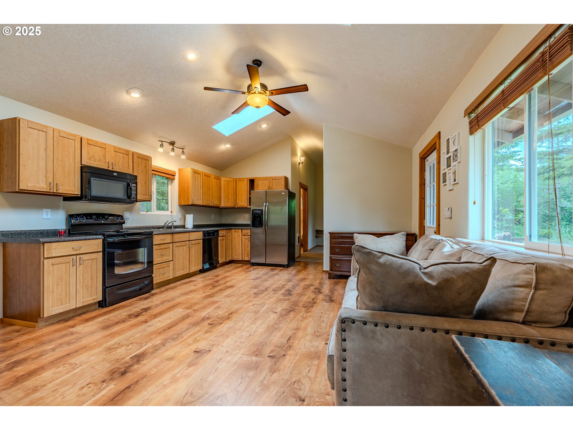 43144 Southeast Deverell Road Corbett, OR 97019 - Photo 42 of 48 a living room with stainless steel appliances kitchen island granite countertop furniture and a flat screen tv