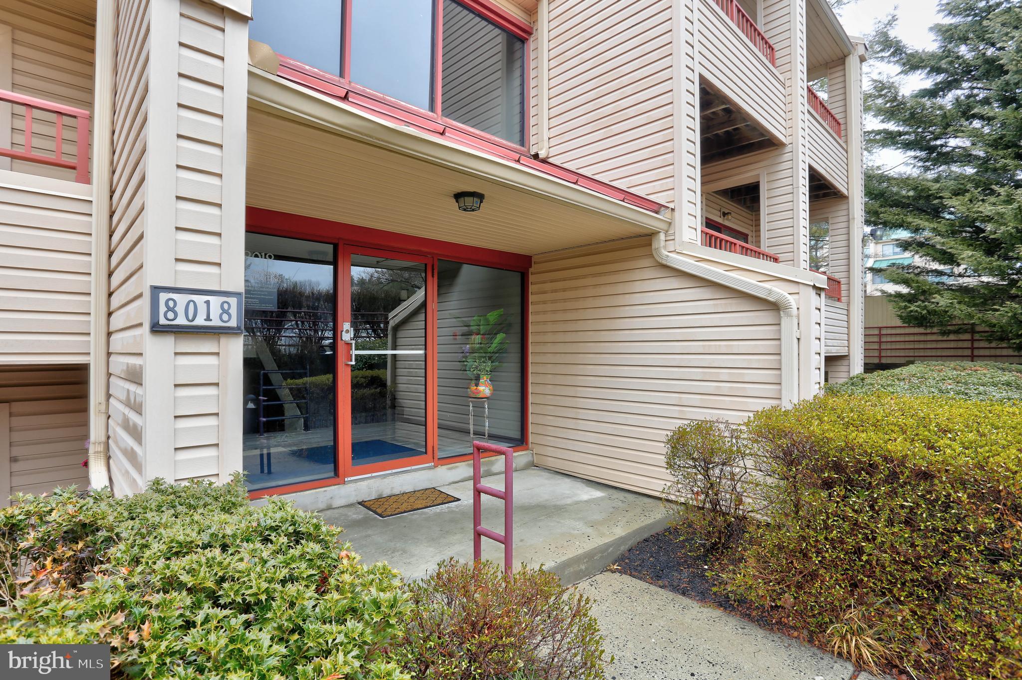 8018 Valley Manor Road, Unit 1A Owings Mills, MD 21117 - Photo 1 of 24 a front view of a house with a yard