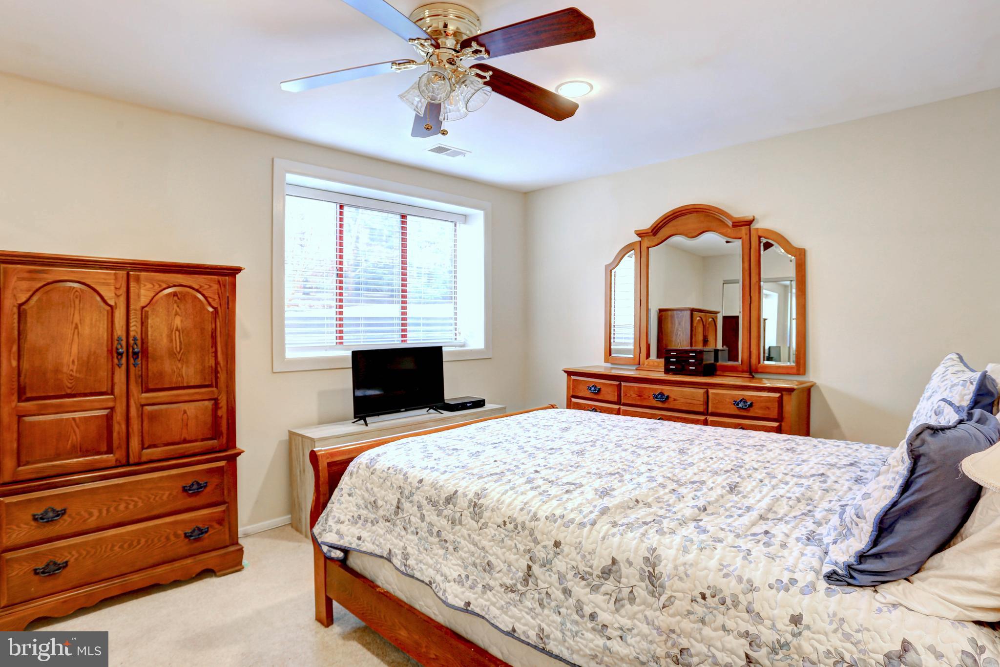 8018 Valley Manor Road, Unit 1A Owings Mills, MD 21117 - Photo 11 of 24 a bedroom with a bed and a dresser