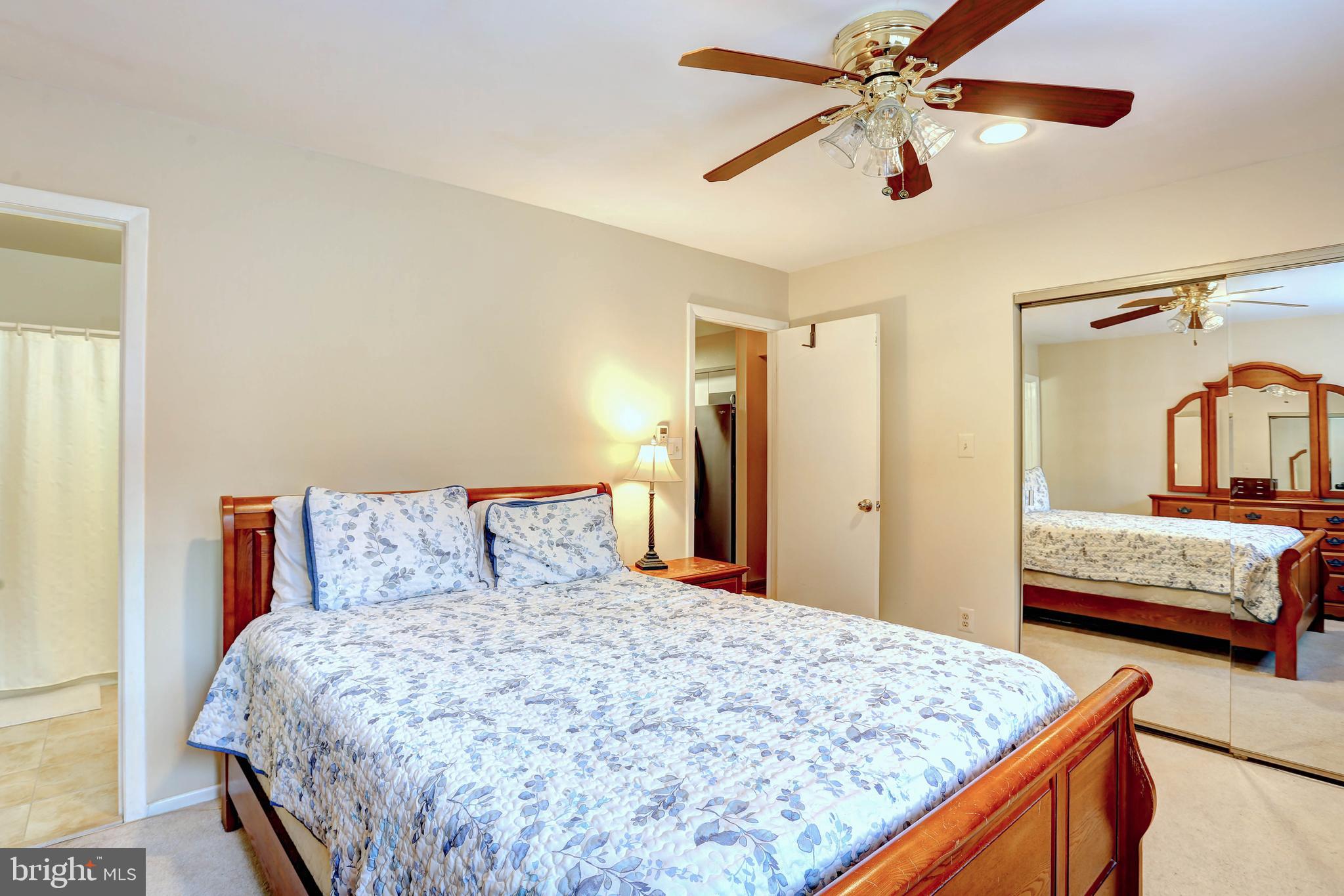 8018 Valley Manor Road, Unit 1A Owings Mills, MD 21117 - Photo 12 of 24 a bedroom with a large bed and a dresser