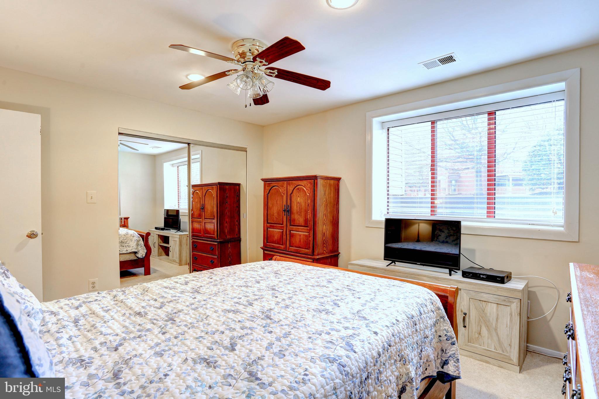 8018 Valley Manor Road, Unit 1A Owings Mills, MD 21117 - Photo 13 of 24 a bedroom with a bed and a dresser