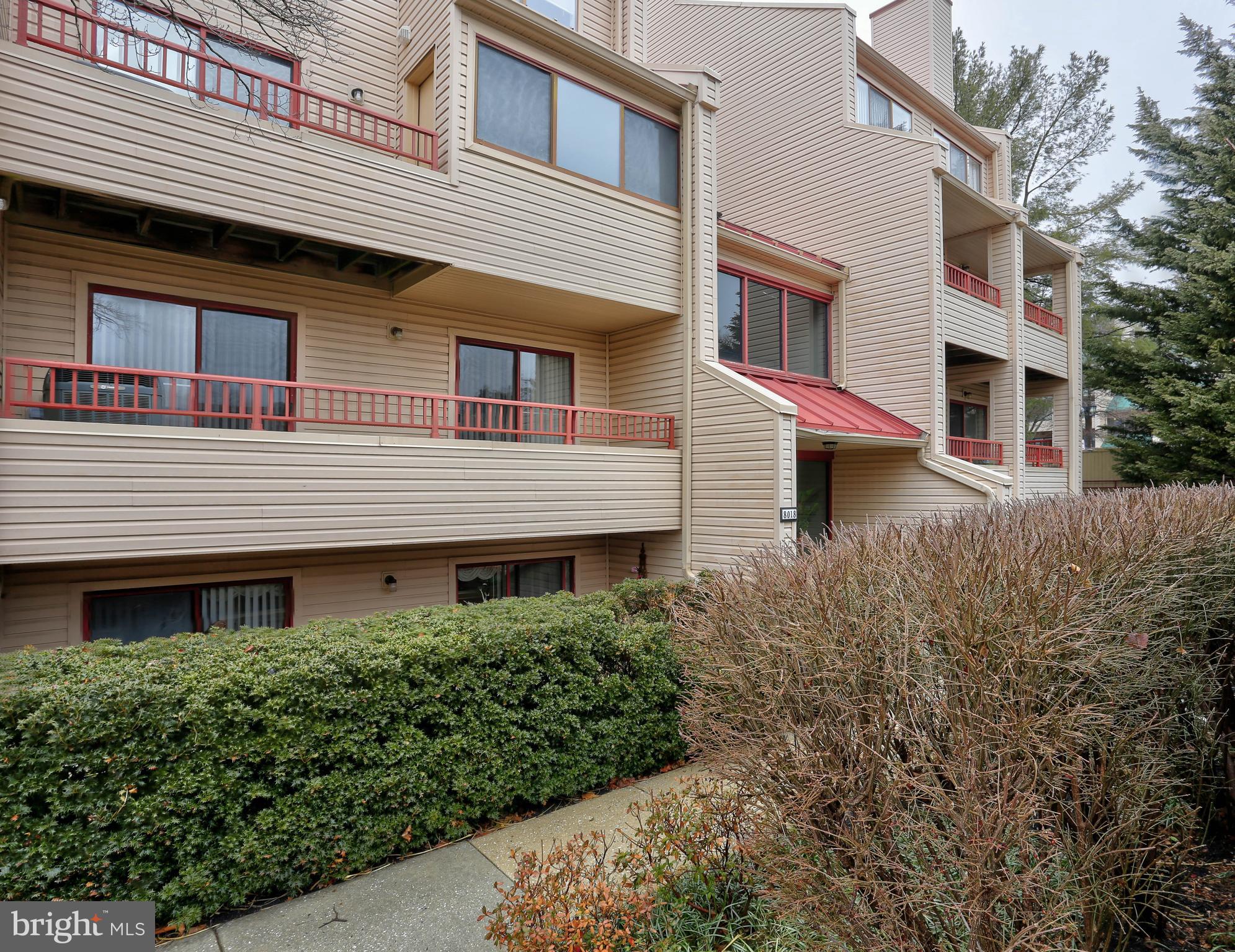 8018 Valley Manor Road, Unit 1A Owings Mills, MD 21117 - Photo 2 of 24 a front view of a house with a garden