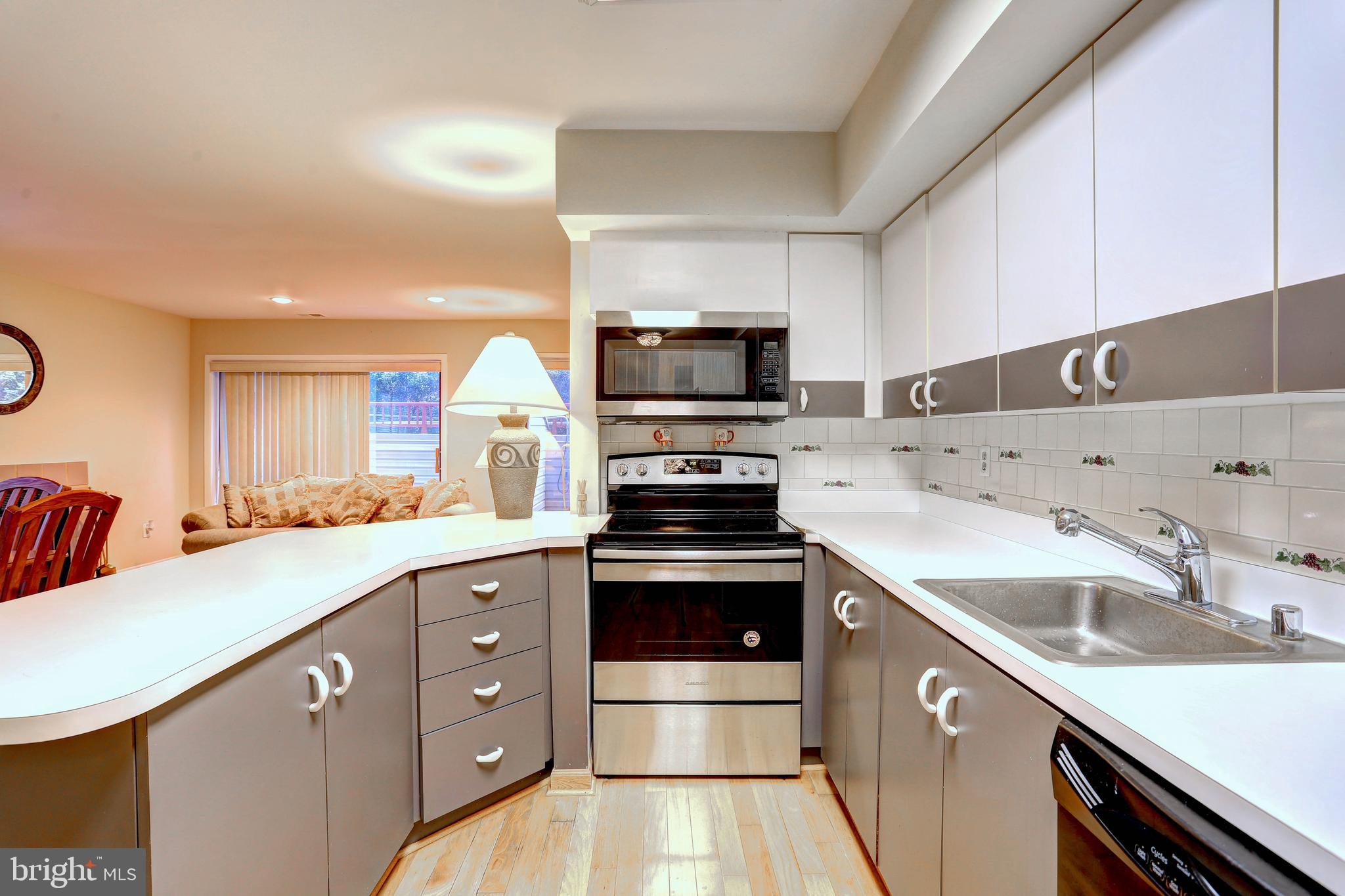 8018 Valley Manor Road, Unit 1A Owings Mills, MD 21117 - Photo 3 of 24 a kitchen with a sink stove and microwave