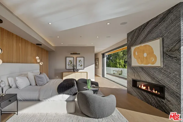 a living room with fireplace furniture and a flat screen tv