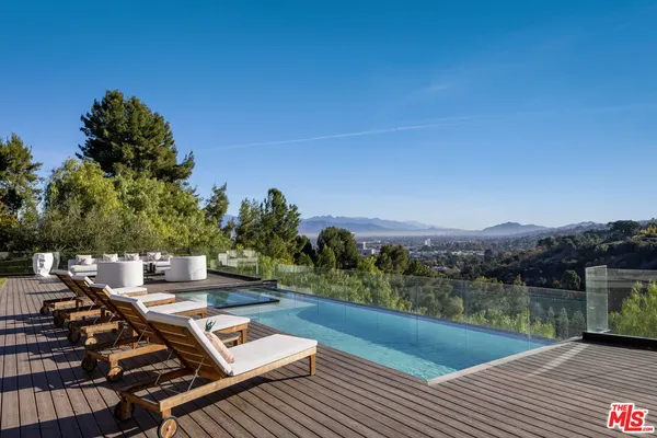 a view of a balcony with mountain view and wooden floor