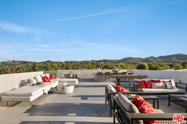 a terrace with outdoor seating and city view