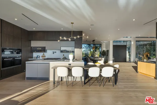 a large kitchen with a table and chairs