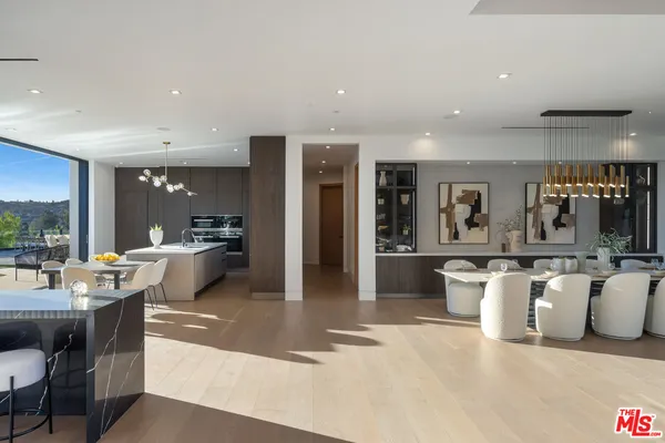 a large kitchen with a table and chairs