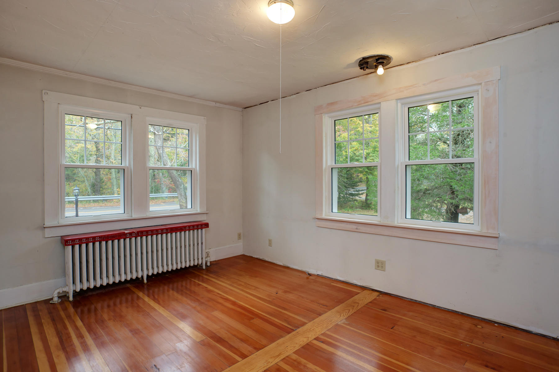 27 County Road Monument Beach, MA 02532 - Photo 13 of 17 a view of an empty room with wooden floor and a window