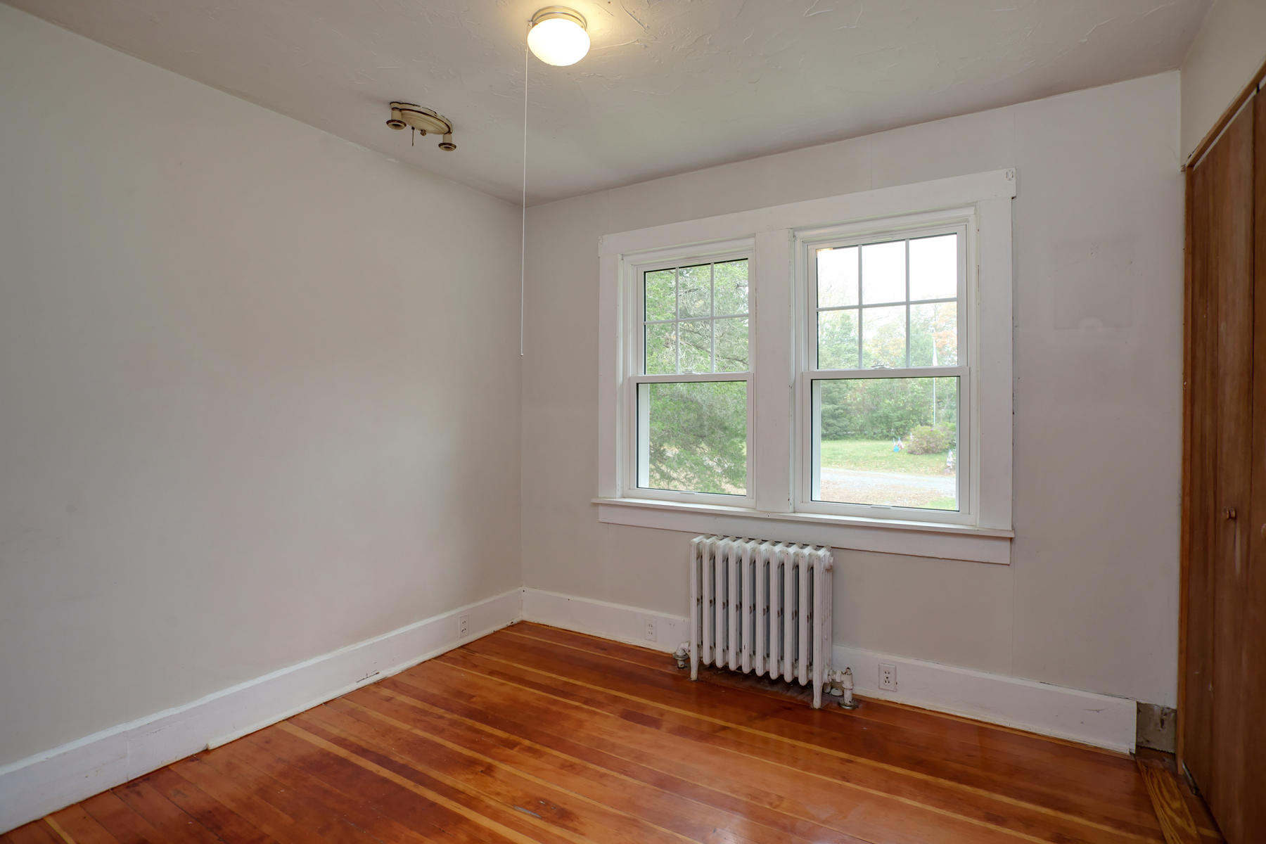 27 County Road Monument Beach, MA 02532 - Photo 14 of 17 an empty room with wooden floor and windows