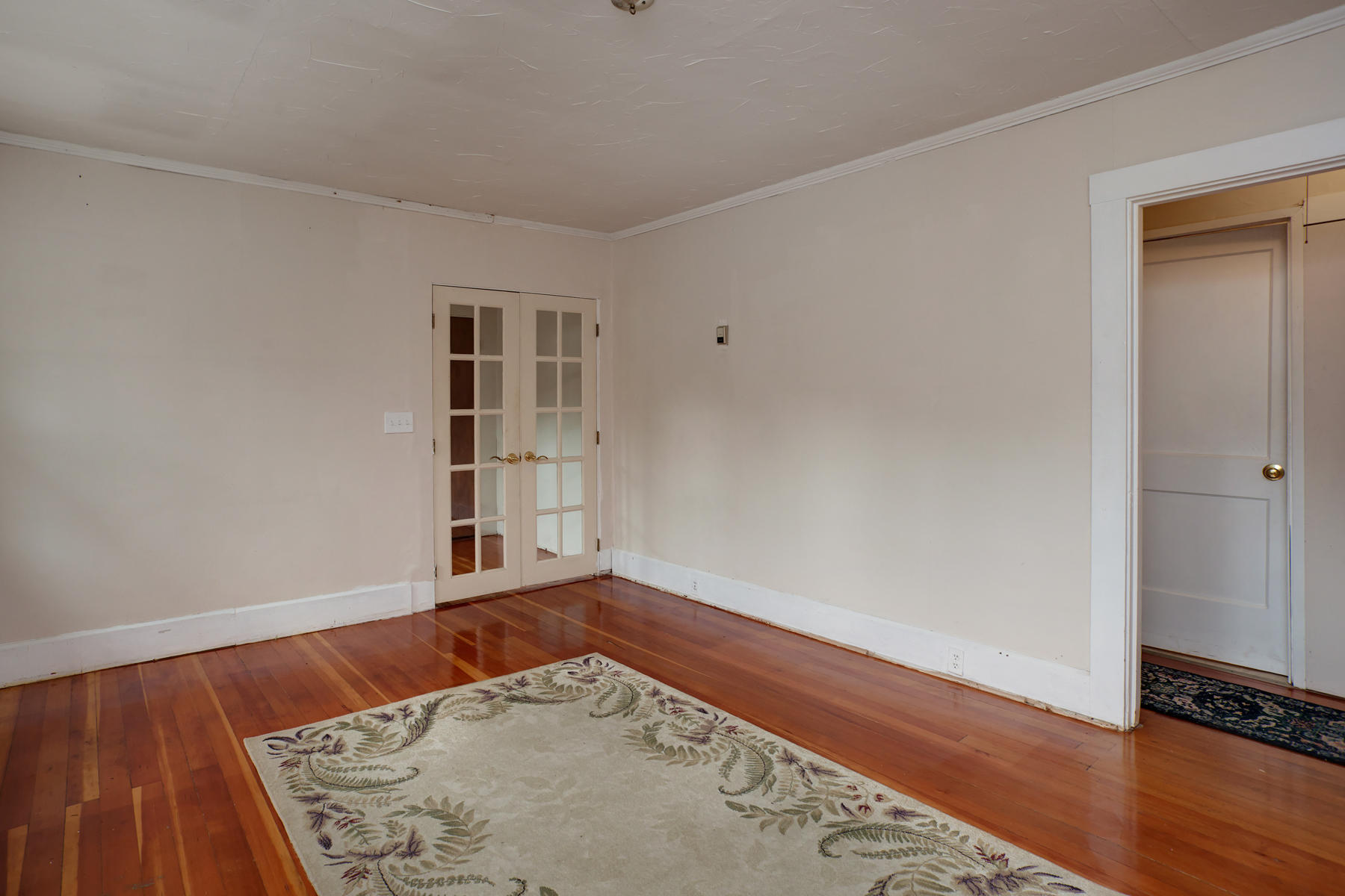 27 County Road Monument Beach, MA 02532 - Photo 4 of 17 an empty room with wooden floor and closet
