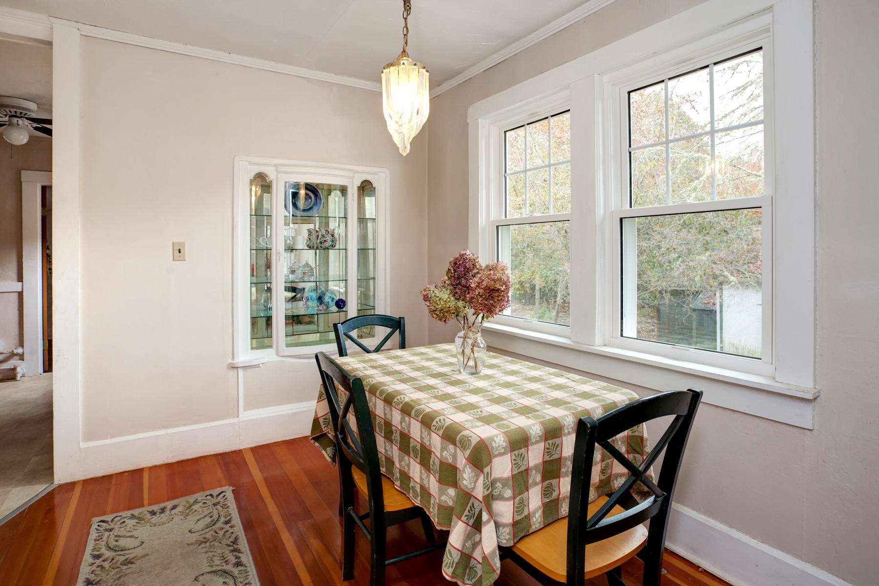 27 County Road Monument Beach, MA 02532 - Photo 7 of 17 a view of a dining room with furniture wooden floor and a chandelier