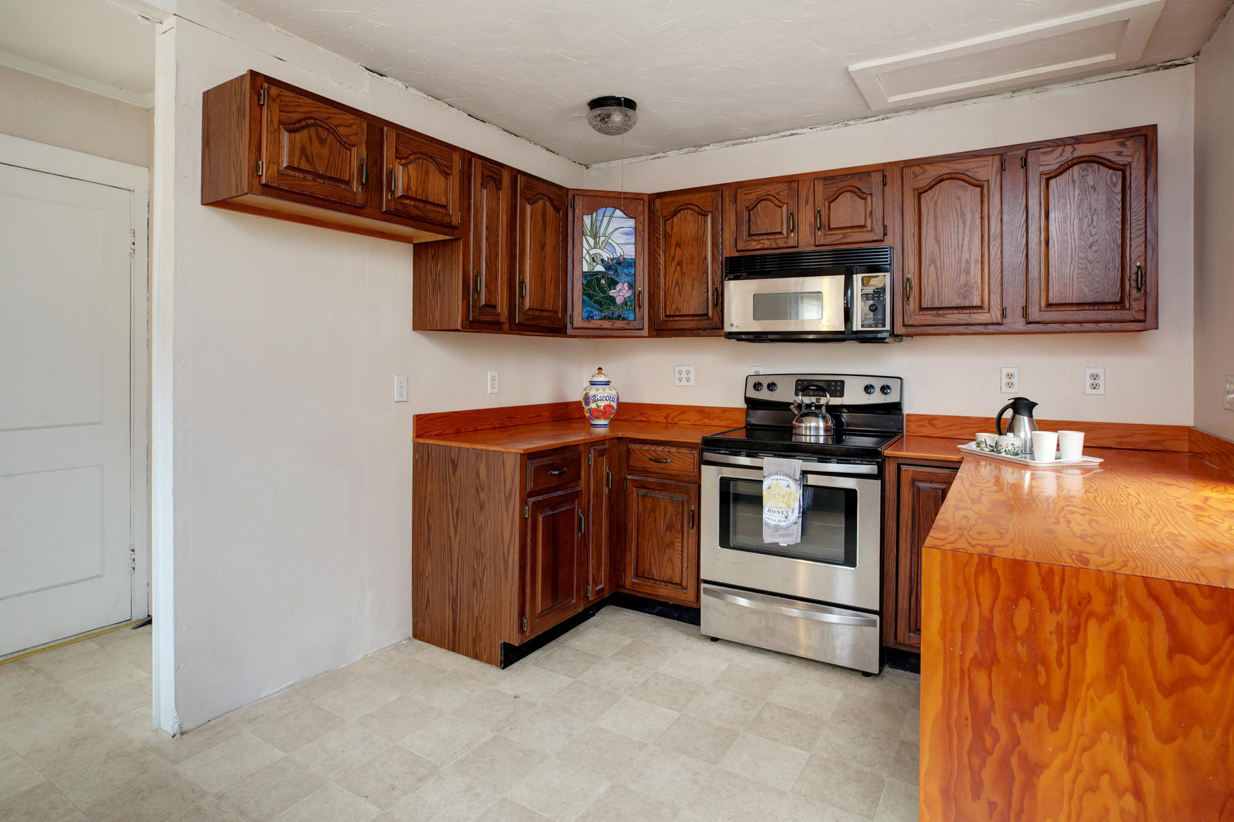 27 County Road Monument Beach, MA 02532 - Photo 8 of 17 a kitchen with stainless steel appliances granite countertop a stove and a sink