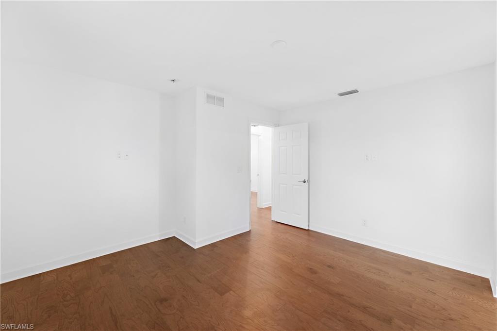 1175 9th Avenue North Naples, FL 34102 - Photo 20 of 33 Spare room featuring wood-type flooring