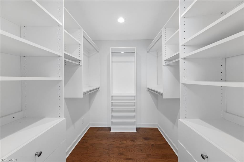 1175 9th Avenue North Naples, FL 34102 - Photo 21 of 33 Walk in closet featuring dark hardwood / wood-style flooring