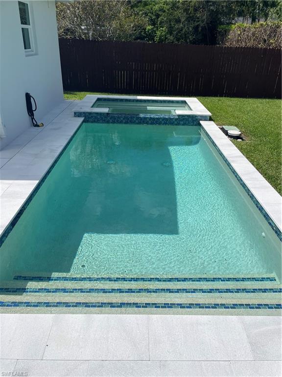 1175 9th Avenue North Naples, FL 34102 - Photo 31 of 33 View of pool featuring a pool with connected hot tub and a patio area