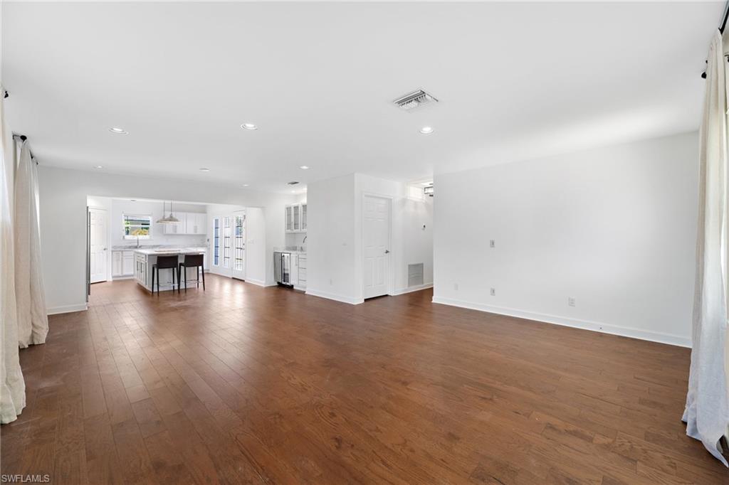 1175 9th Avenue North Naples, FL 34102 - Photo 5 of 33 Unfurnished living room with dark wood-type flooring
