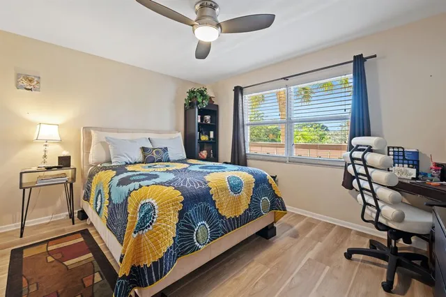 a bedroom with a bed a table and a chandelier