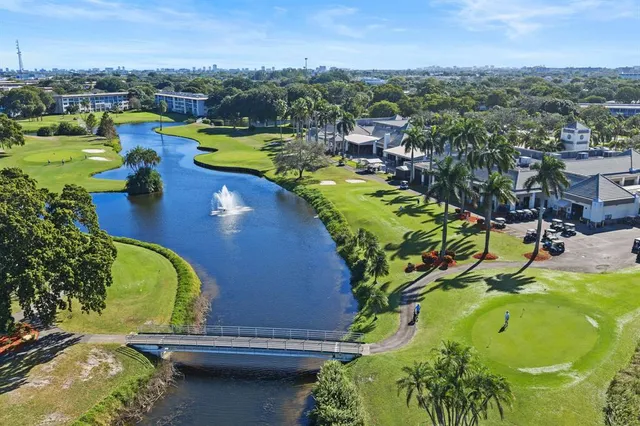 an aerial view of a swimming pool with a yard