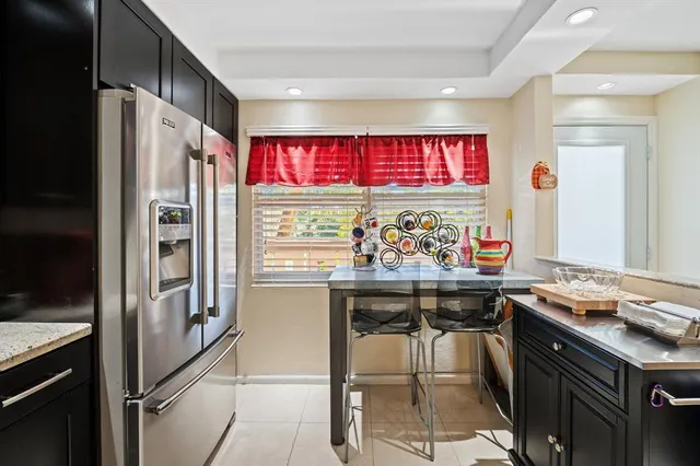 a view of a kitchen with stainless steel appliances granite countertop a stove and a refrigerator