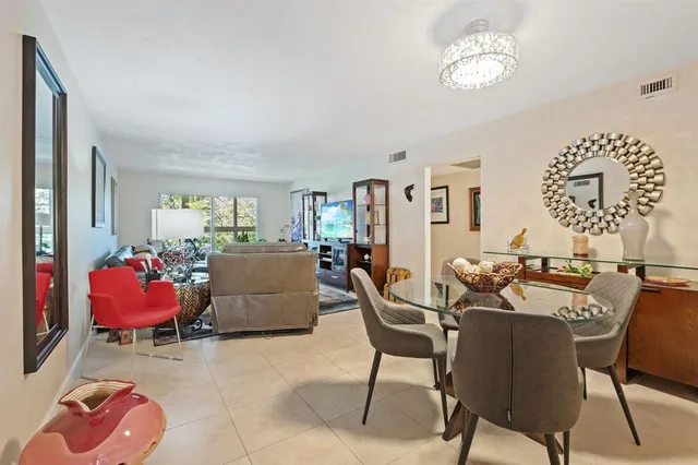 a view of a dining room with furniture and chandelier