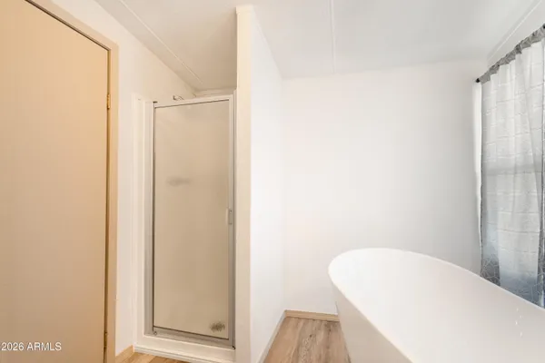 a view of a bathroom with a tub and shower