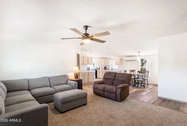 a living room with furniture a ceiling fan and a rug