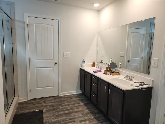 a bathroom with a sink vanity and a mirror