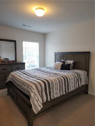 a bedroom with a bed and window