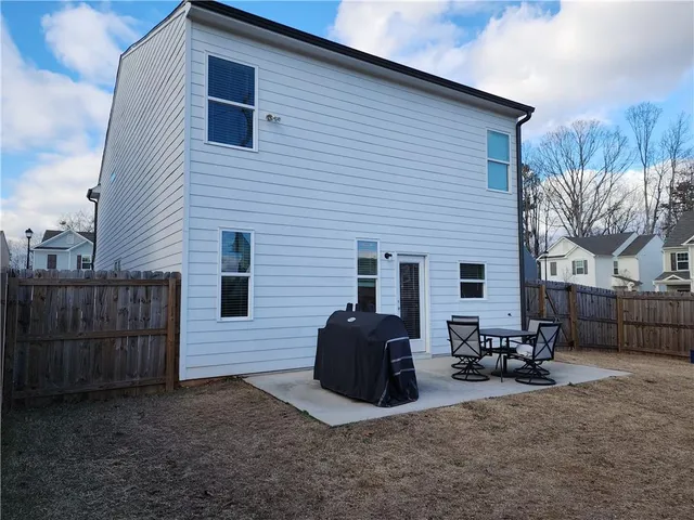 a couple of chairs in front of house