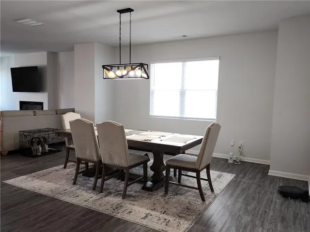 a view of a dining room with furniture window and wooden floor